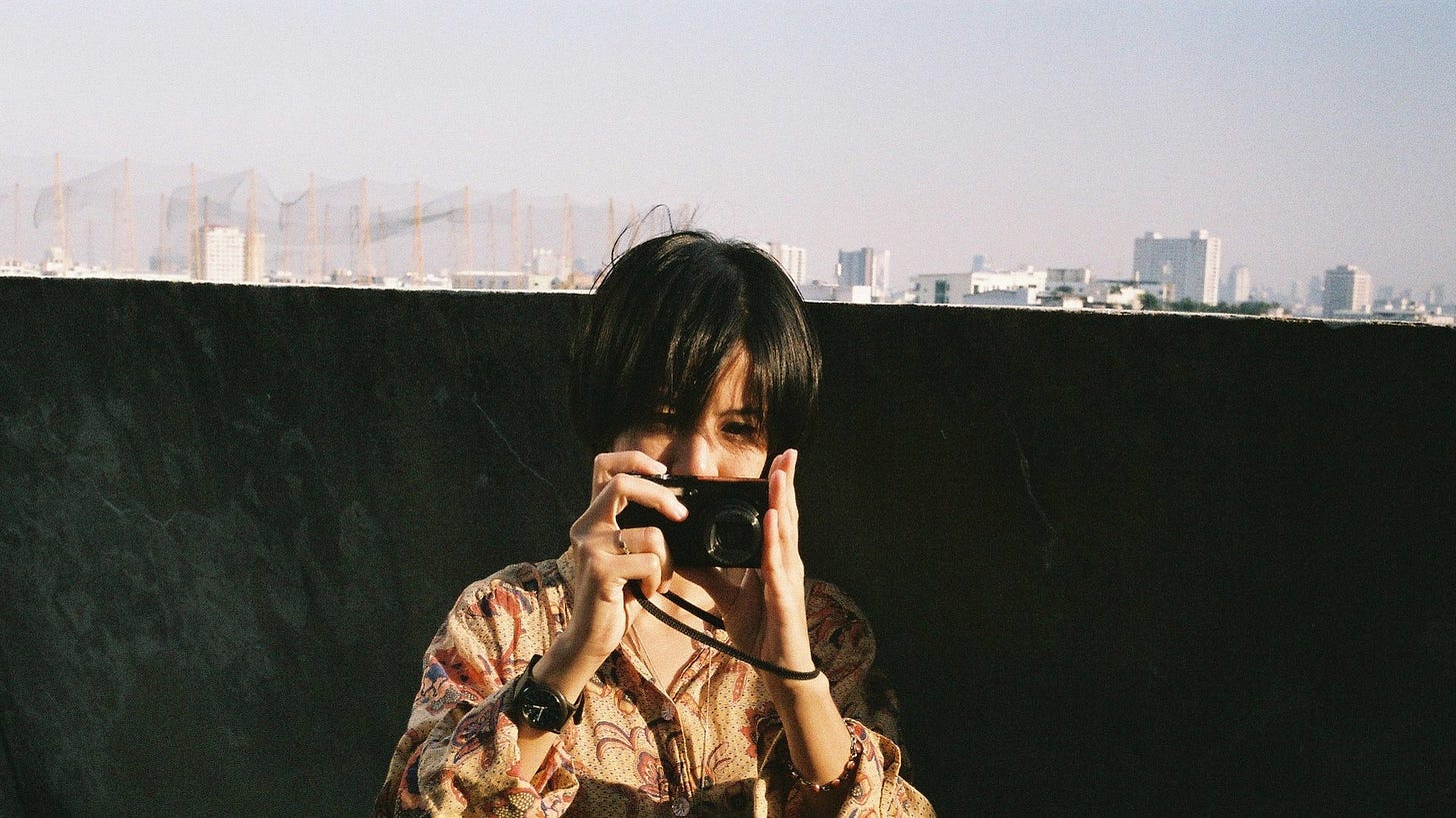 36 | Still features a girl taking a picture.