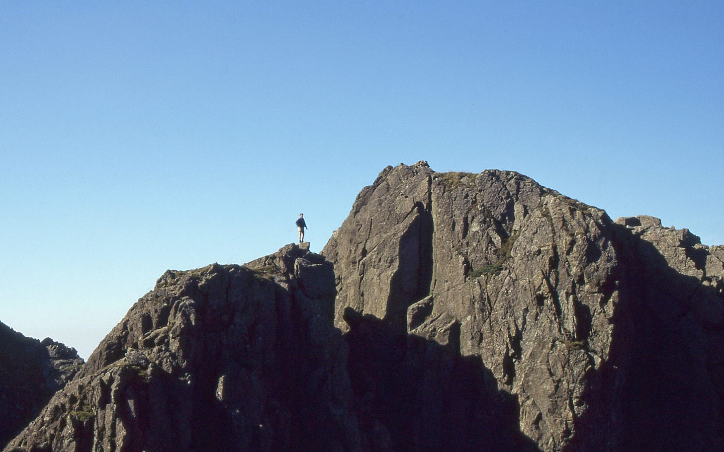 Person (me) on smaller rock tower with bigger steeper one alongside