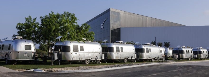 The SpaceX production facility towers over Airstream trailers where SpaceX employees live near Boca Chica Village, Texas on March 28, 2025. 