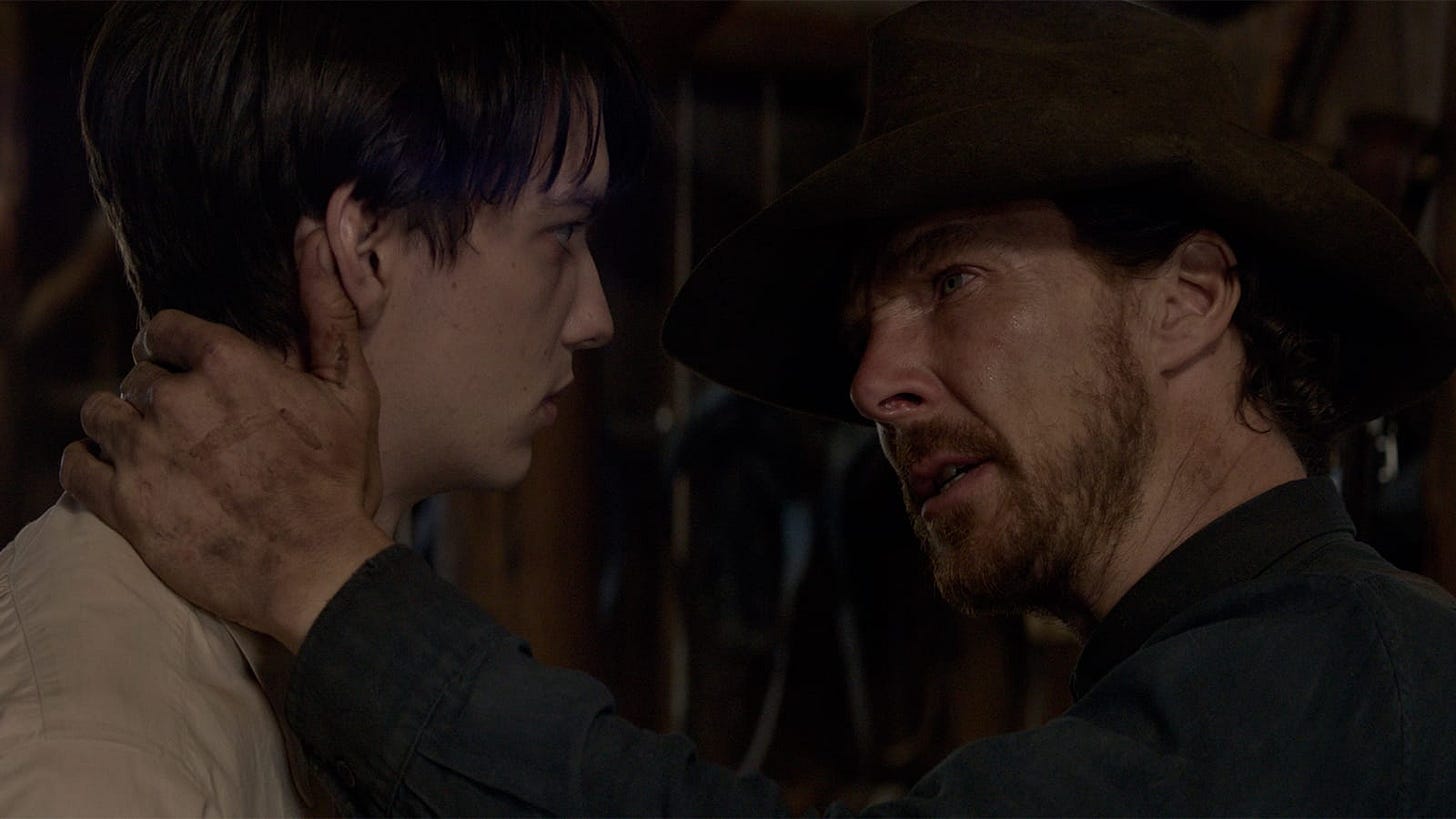 The Power of the Dog | Still features Benedict Cumberbatch as Phil Burbank in an embrace with Kodi Smit-McPhee as Peter Gordon.