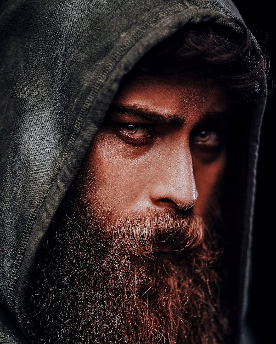 a man with a beard and a hoodie
