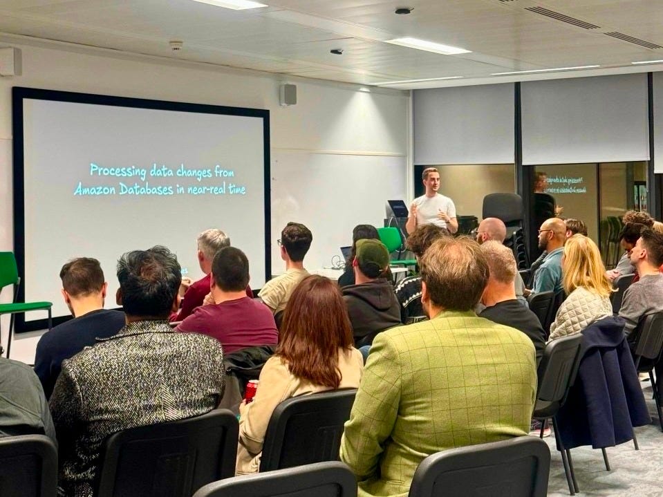 Me introducing myself to the Meetup group with a presentation slide that says "Processing data changes from Amazon Databases in near-real time". Me introducing myself to the Meetup group with a presentation slide that says "Processing data changes from Amazon Databases in near-real time".