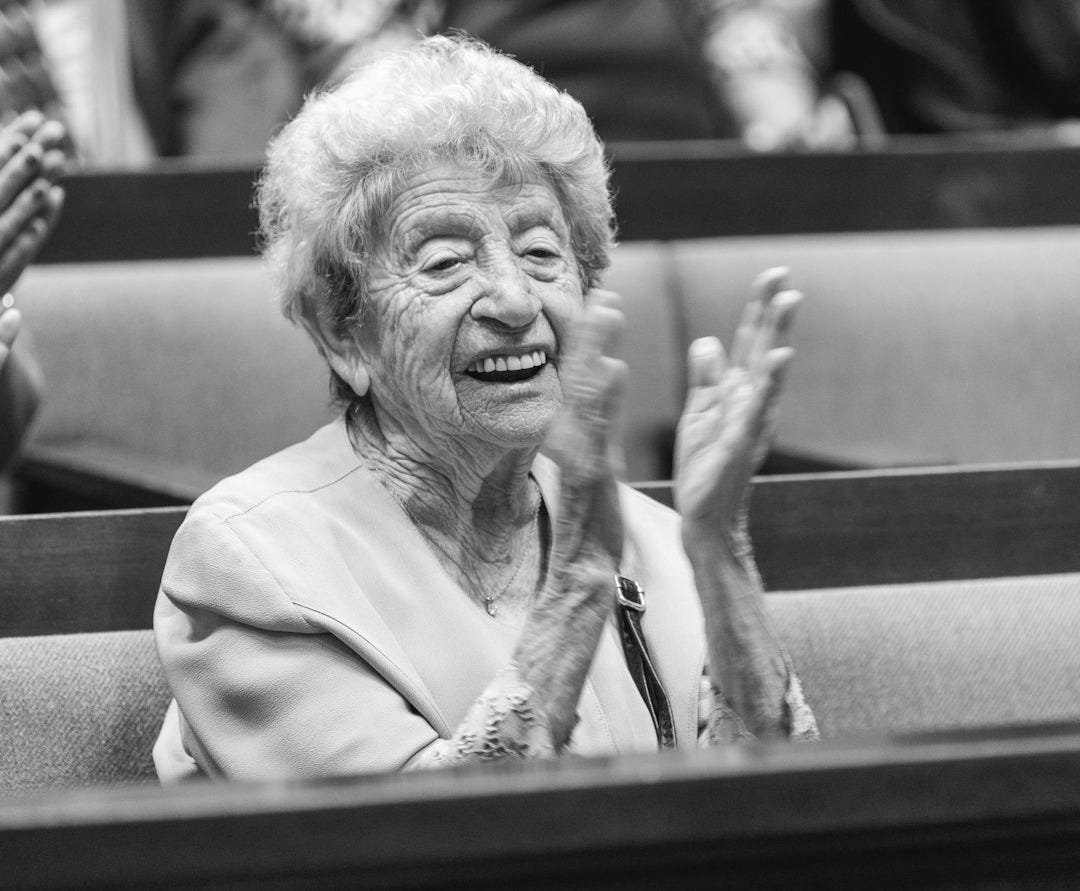 a woman sitting in a chair clapping