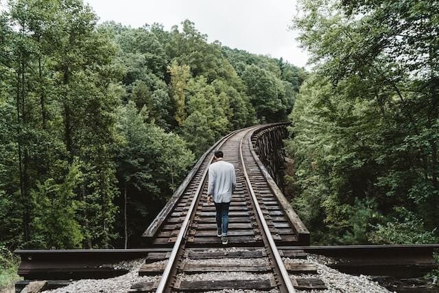 Man walking down a raised railway. Man walking down a raised railway.