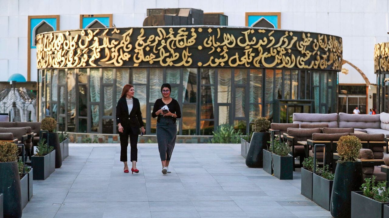 People walk at one of the restaurants and cafes at the "One thousand And One Nights" entertainment resort on the bank of the Tigris River in Baghdad People walk at one of the restaurants and cafes at the "One thousand And One Nights" entertainment resort on the bank of the Tigris River in Baghdad