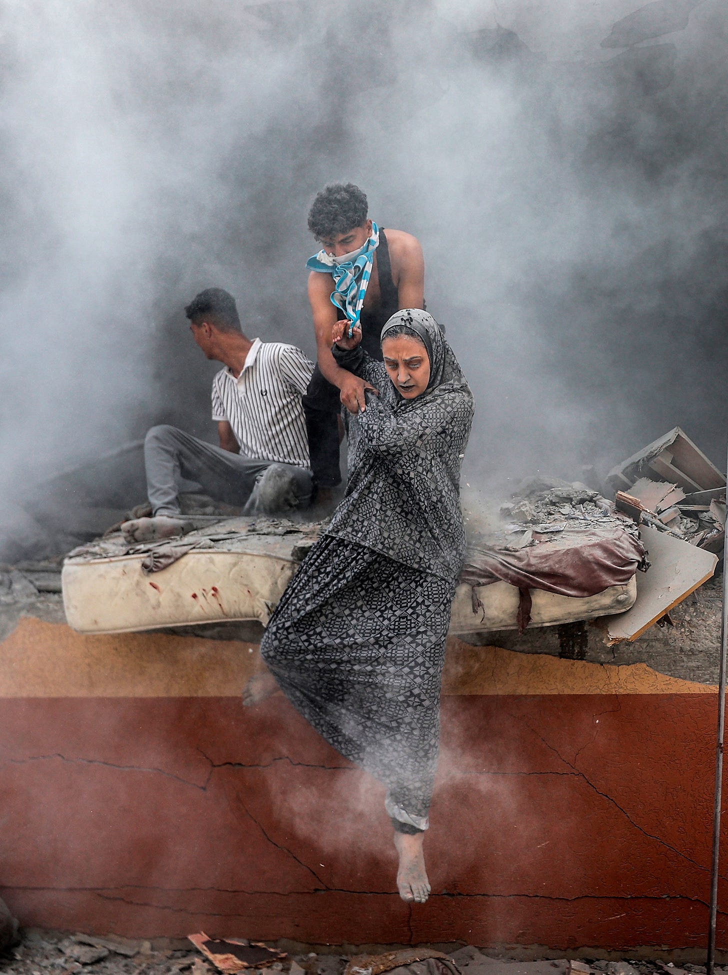 Israeli attacks on Gaza continue Palestinians emerge from the rubble and dust after an Israeli attack hit the Abu Aisha family’s house in Deir al-Balah, Gaza, on June 14. Ali Jadallah—Anadolu/Getty Images.