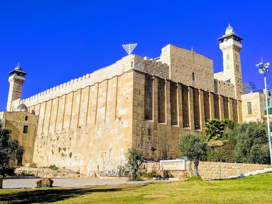 brown concrete building near green trees during daytime