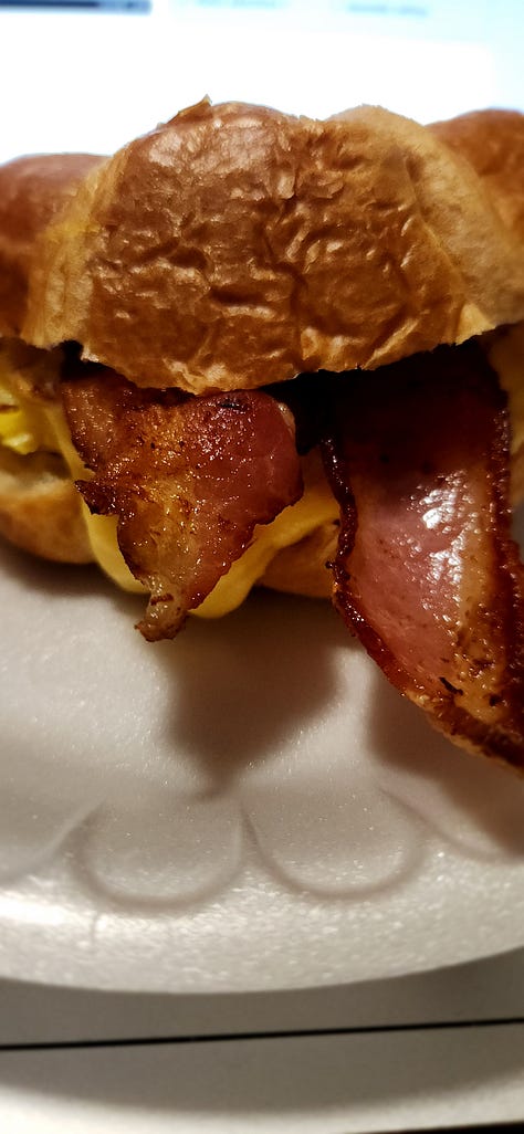 three pictures showing different angles of a homemade bacon, egg, and cheese breakfast sandwich on a croissant.