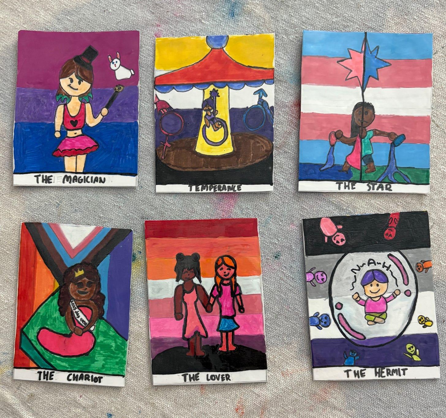 Tarot cards with different pride flags as the background, handdrawn in marker