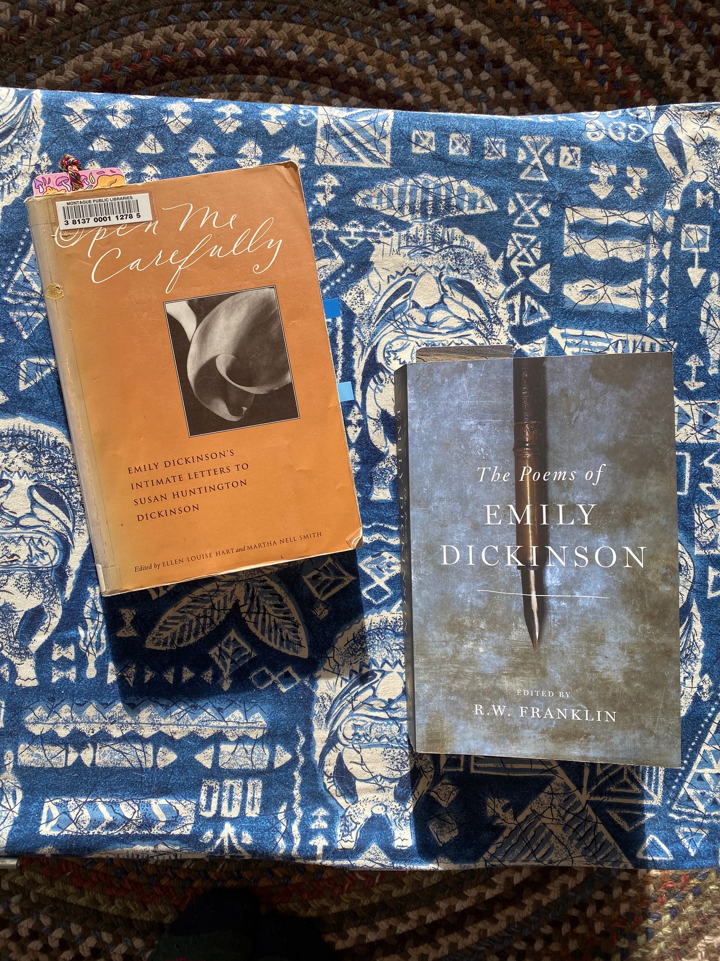 Open Me Carefully and The Poems of Emily Dickinson on a coffee table.