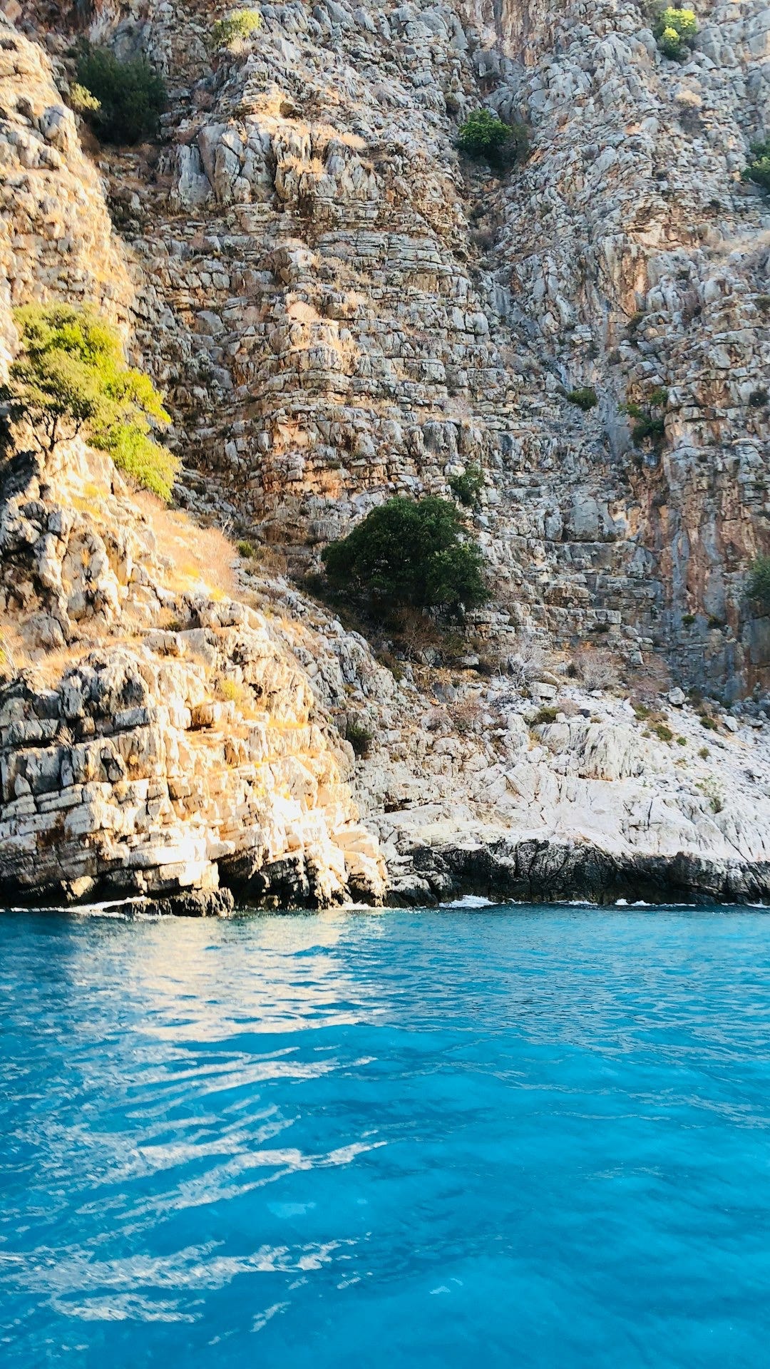 calm body of water near cliffs calm body of water near cliffs