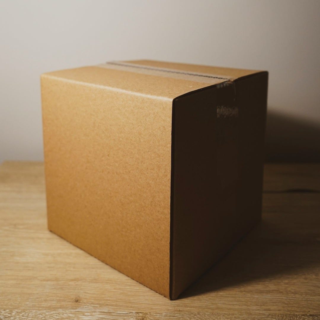 shallow focus photo of brown cardboard box shallow focus photo of brown cardboard box