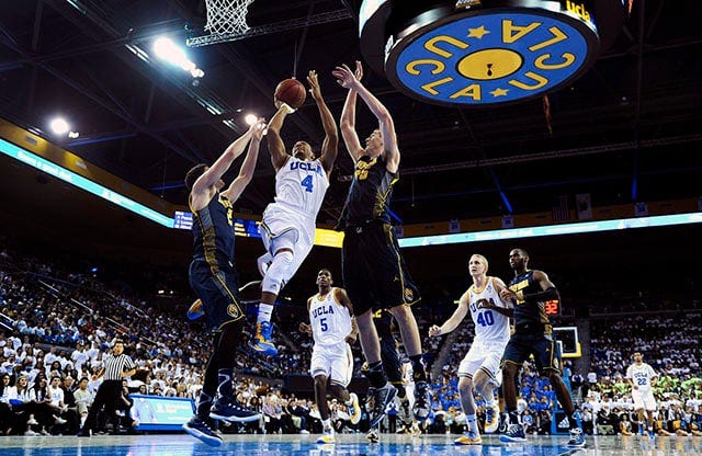 Jan 11, 2015; Los Angeles, CA, USA; UCLA Bruins guard Norman Powell (4) drives to the hoop between California Golden Bears guard Sam Singer (2) and Golden Bears forward David Kravish (45) during the second half at Pauley Pavilion. Robert Hanashiro/USA TODAY Sports