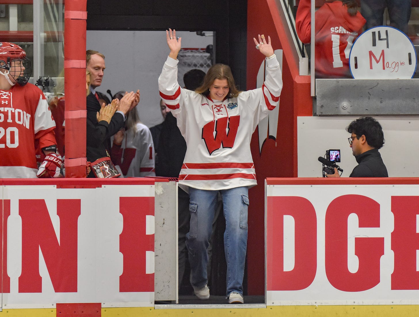 McKayla Zilisch waves with both hands as she walks onto the ice