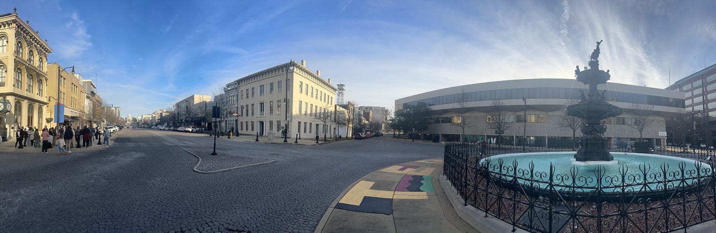 Court Square Fountain in the foreground. Prior to the Civil War, this location served as the city’s main auction block for enslaved people and other property. The three-story Winter Building stands in the center of the image as Dexter Avenue continues to the left toward the Alabama State Capitol. Court Square Fountain in the foreground. Prior to the Civil War, this location served as the city’s main auction block for enslaved people and other property. The three-story Winter Building stands in the center of the image as Dexter Avenue continues to the left toward the Alabama State Capitol.