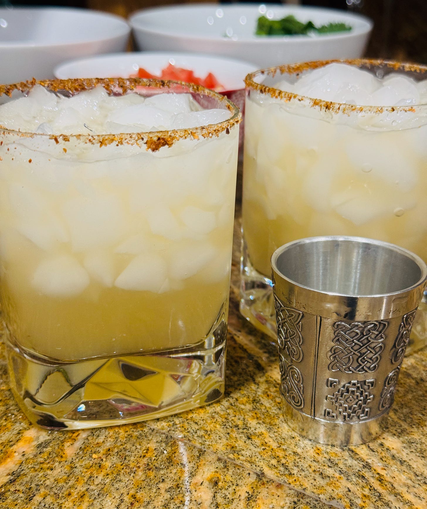 Cocktail recipe: two citrus Tajin margaritas with Tajin rimmed glasses and Celtic jigger. Cocktail recipe: two citrus Tajin margaritas with Tajin rimmed glasses and Celtic jigger.