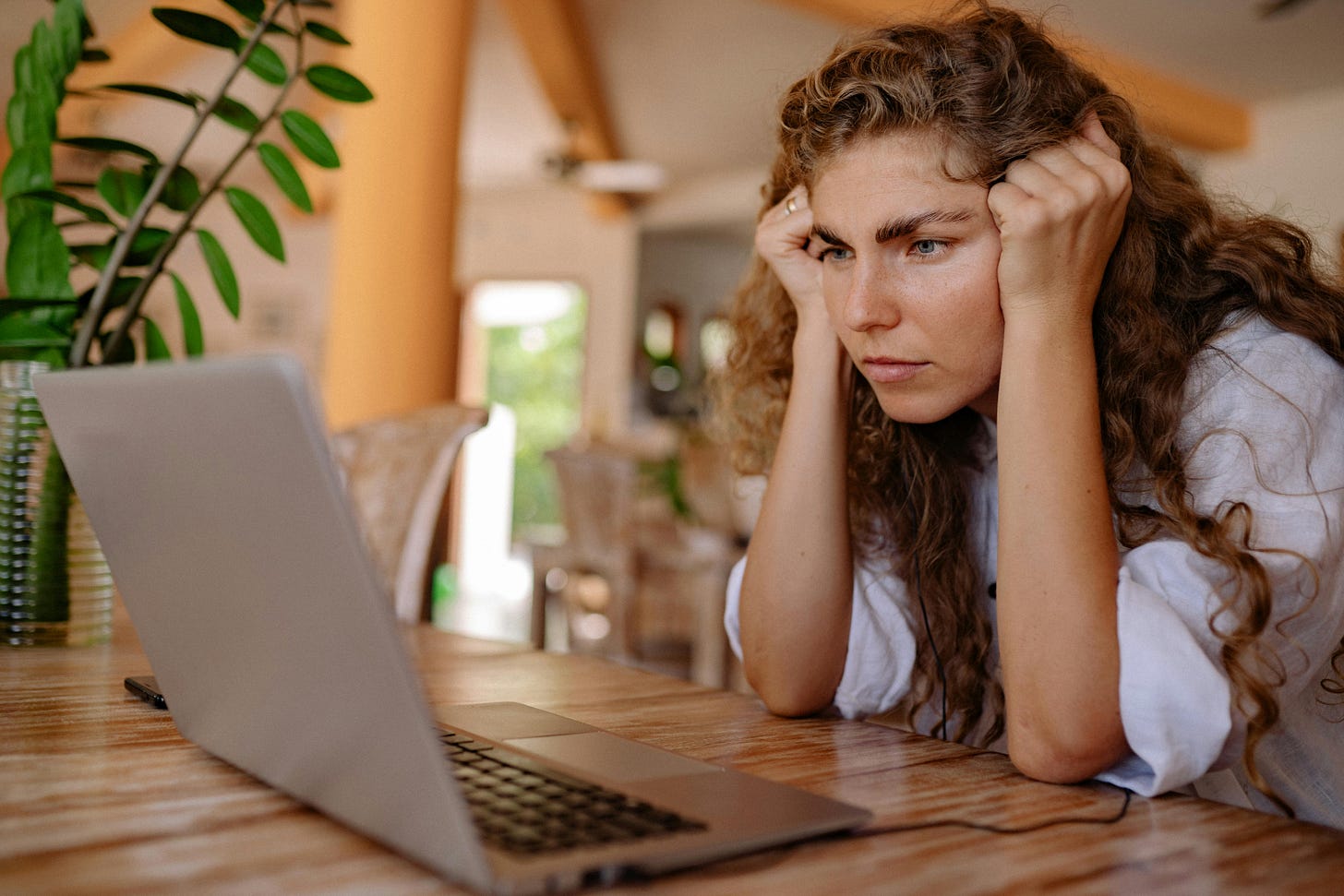 A woman waiting for the computer to unblock.