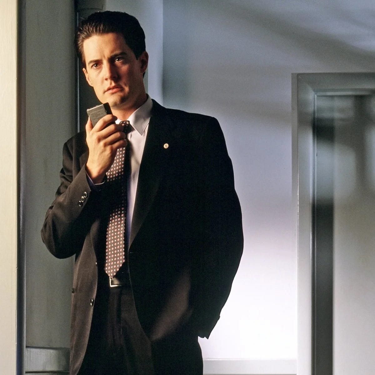 Photo of Special Agent Dale Cooper holding a dictaphone
