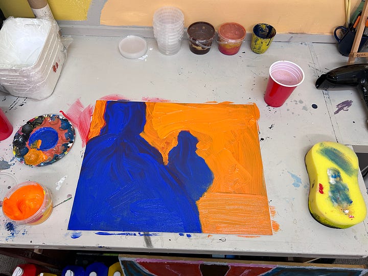 Orange and blue figurative abstract paintings.