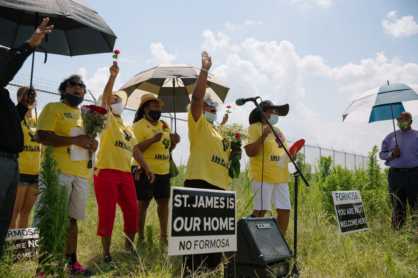 In this June 19, 2020 photo, members of RISE St. James pray over the graves of what are believed to be formerly enslaved Black people buried on the site of the former Buena Vista plantation