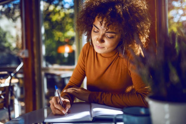 Portrait of a woman writing in a notebook Portrait of a woman writing in a notebook