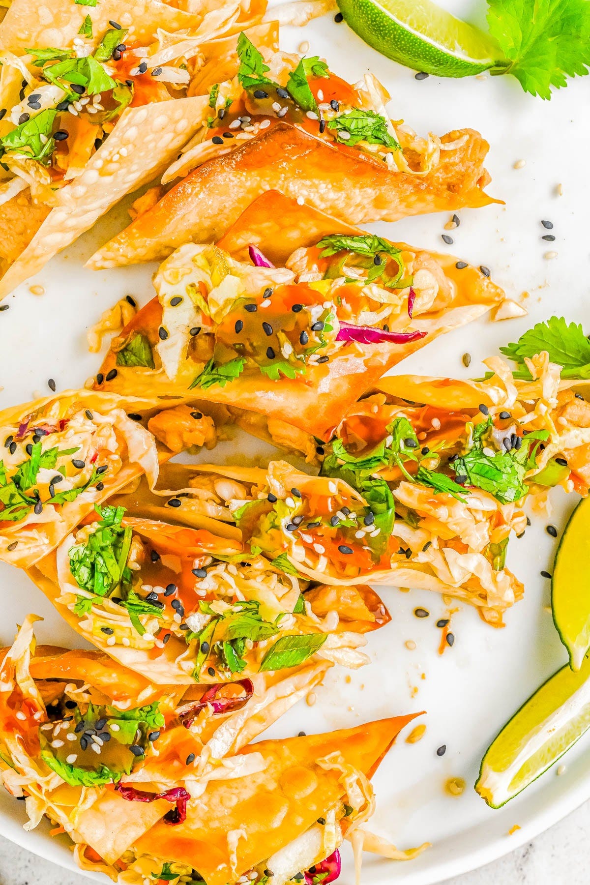 Copycat Applebee's Chicken Wonton Tacos — Crispy, crunchy wonton wrappers are filled with succulent teriyaki chicken and topped with sesame ginger coleslaw to create the best ever chicken wonton tacos! This is a homemade version of Applebee's wonton tacos, but fresher and tastier. If you love Asian-fusion recipes, you’re going to love these tacos!   
