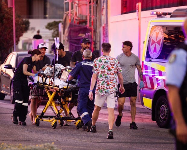 A victim of the Bondi shooting is taken to an ambulance.