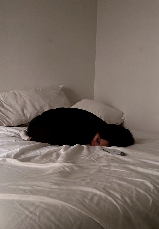 This may contain: a woman laying on top of a bed covered in white sheets with her head resting on the pillow This may contain: a woman laying on top of a bed covered in white sheets with her head resting on the pillow
