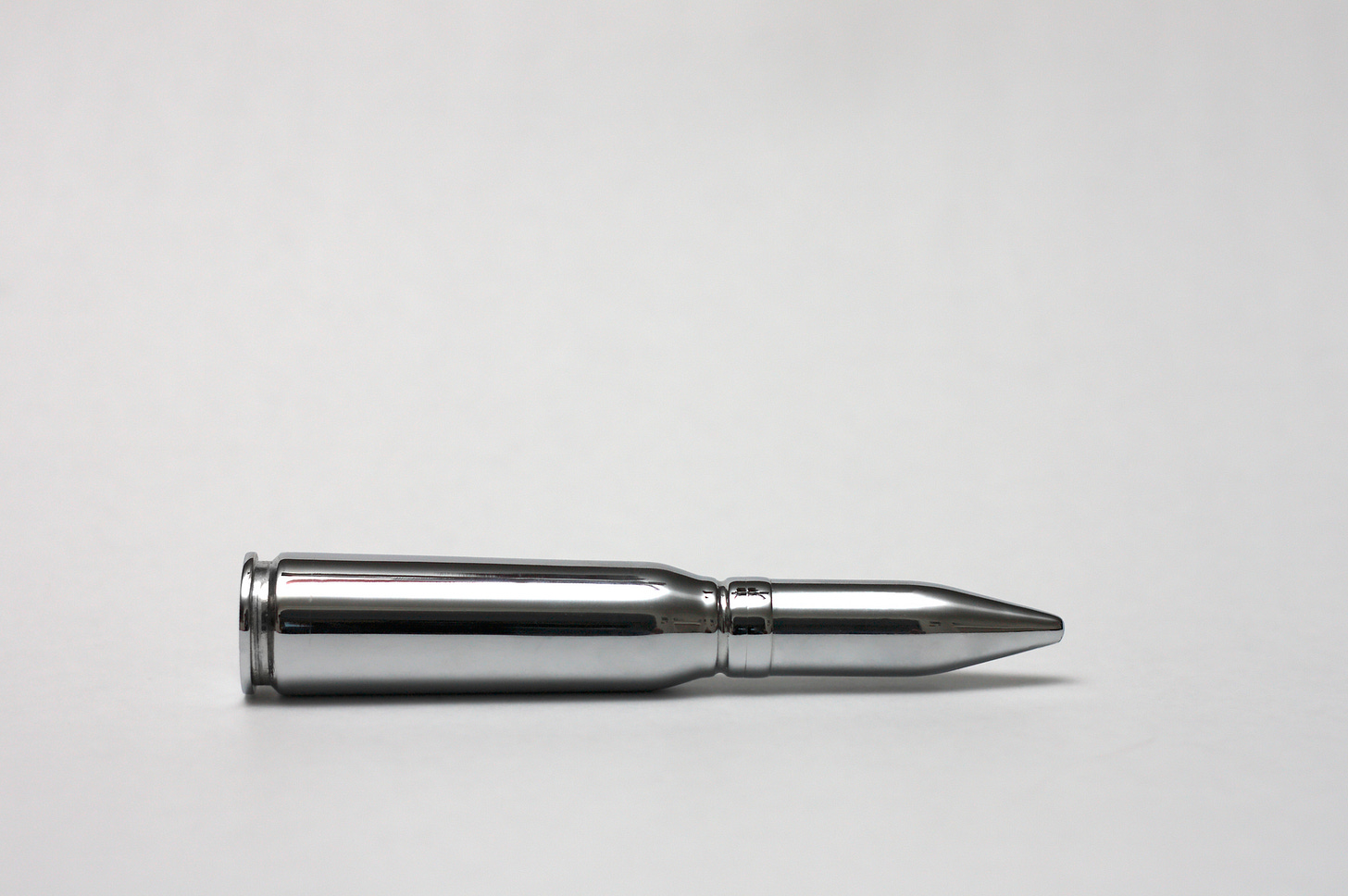 A silver bullet on a white background. A silver bullet on a white background.