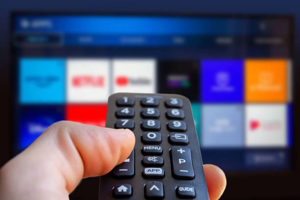 A remote points to an exhausting display of streaming services.