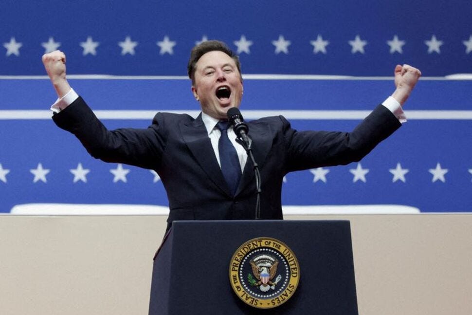 A person in a suit and tie standing at a podium with his hands up

Description automatically generated