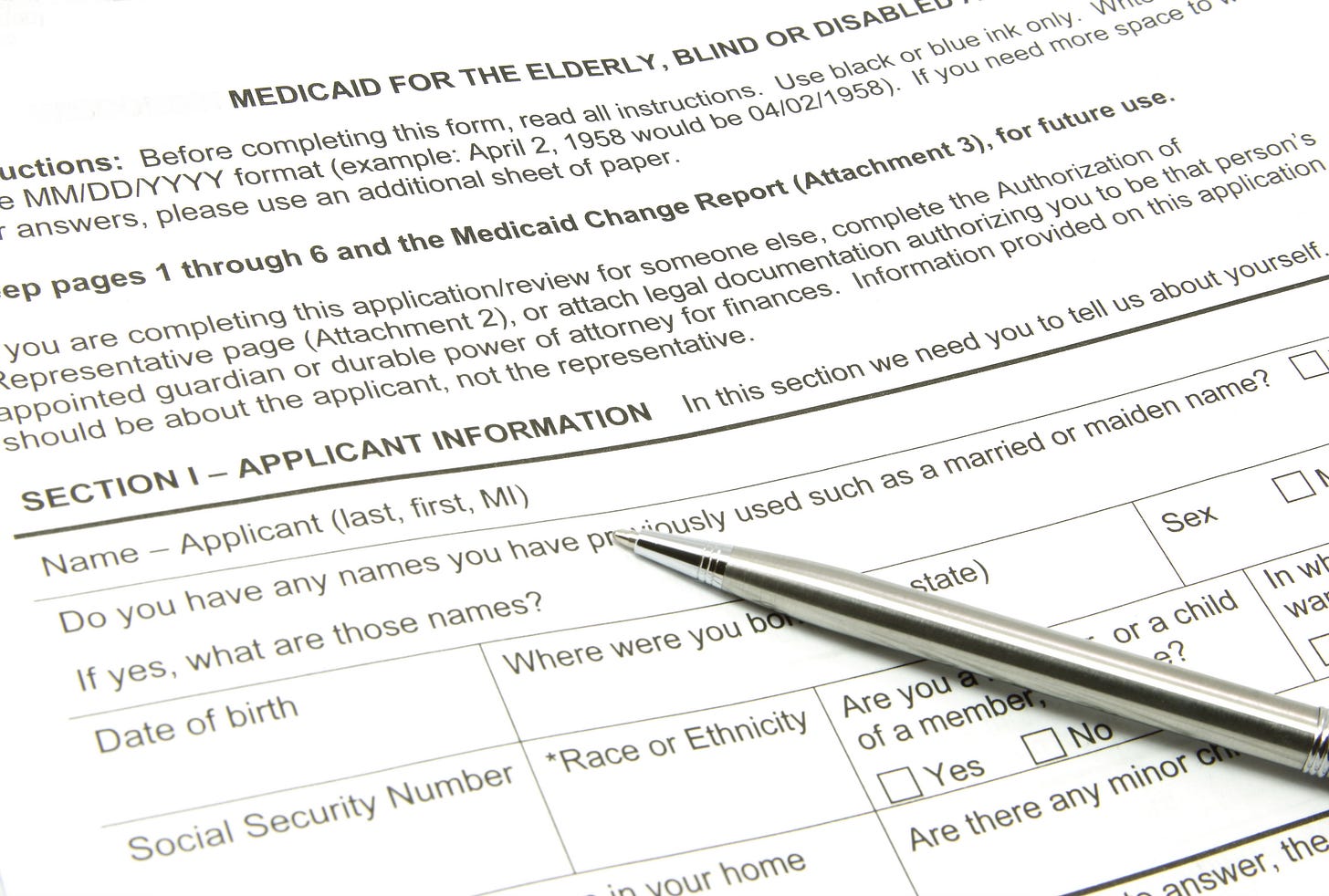 Medicaid application with silver pen on top