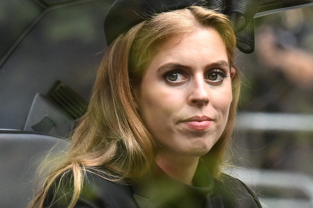 Princess Beatrice looks sad looking out a car window