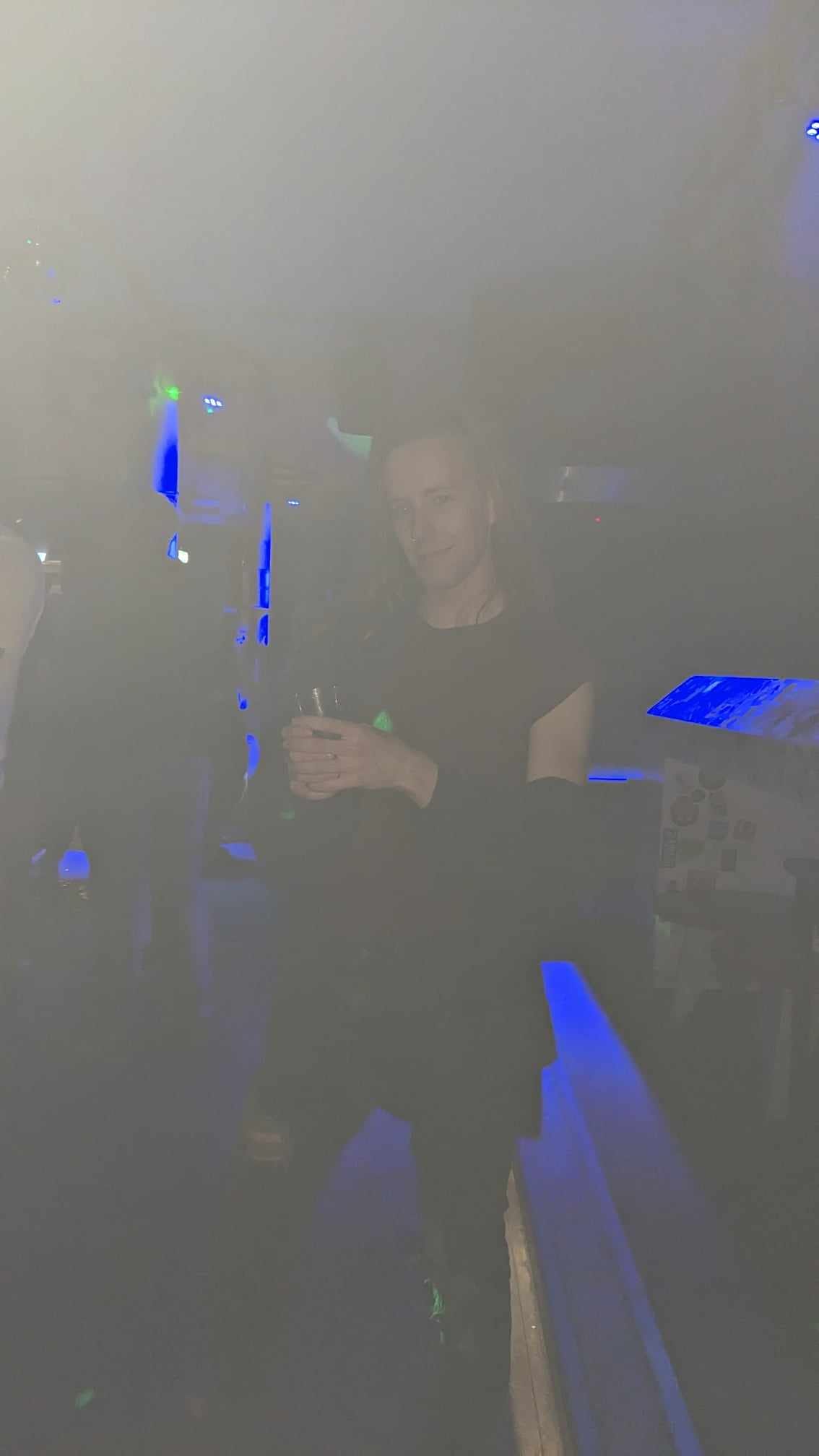 An overexposed image of a man in a dark bar holding a glass An overexposed image of a man in a dark bar holding a glass