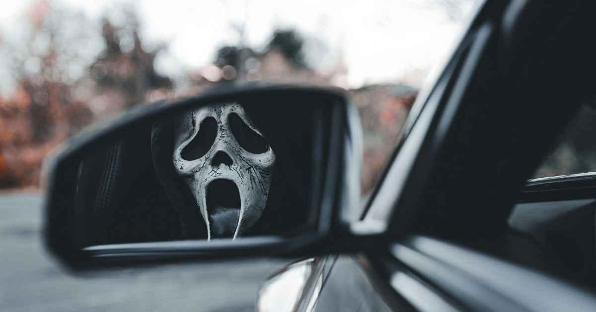 Mysterious Mask Reflected in Car Mirror