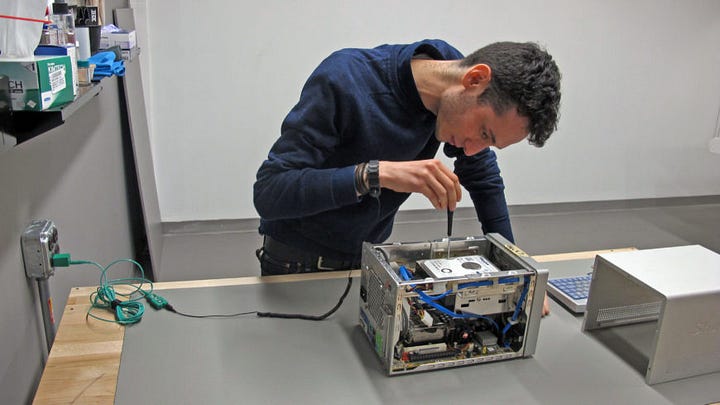 Programmer/restorer extract the hard drive of artist-provided computer, then uses a forensic bridge to back up its contents