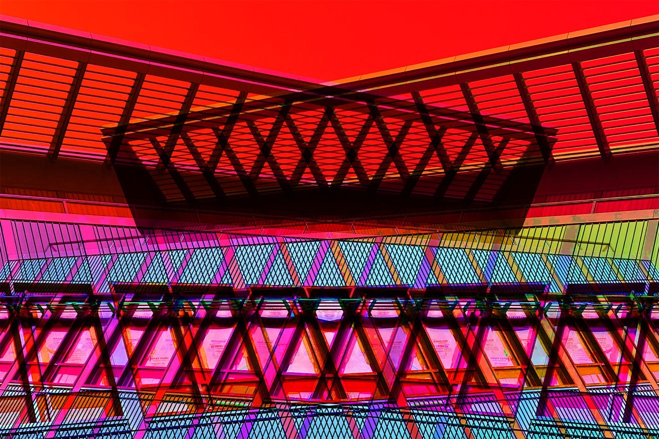 A multicolored building with a red background

Description automatically generated