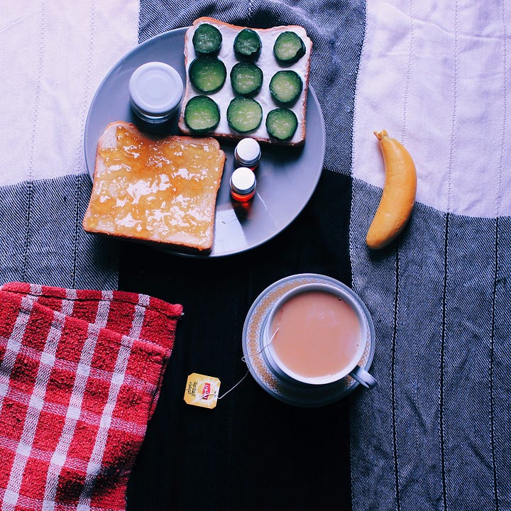 Plate of strawberries on a lap. Toast and tea. Photos by Marjan Sadeki and Alhanouf Khalid via Unsplash.