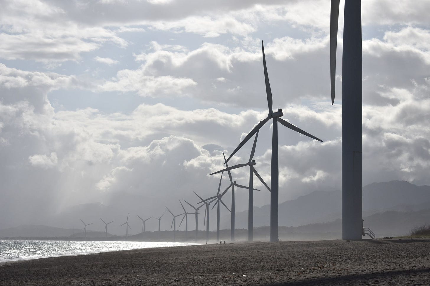 A line of wind turbines on a beach A line of wind turbines on a beach