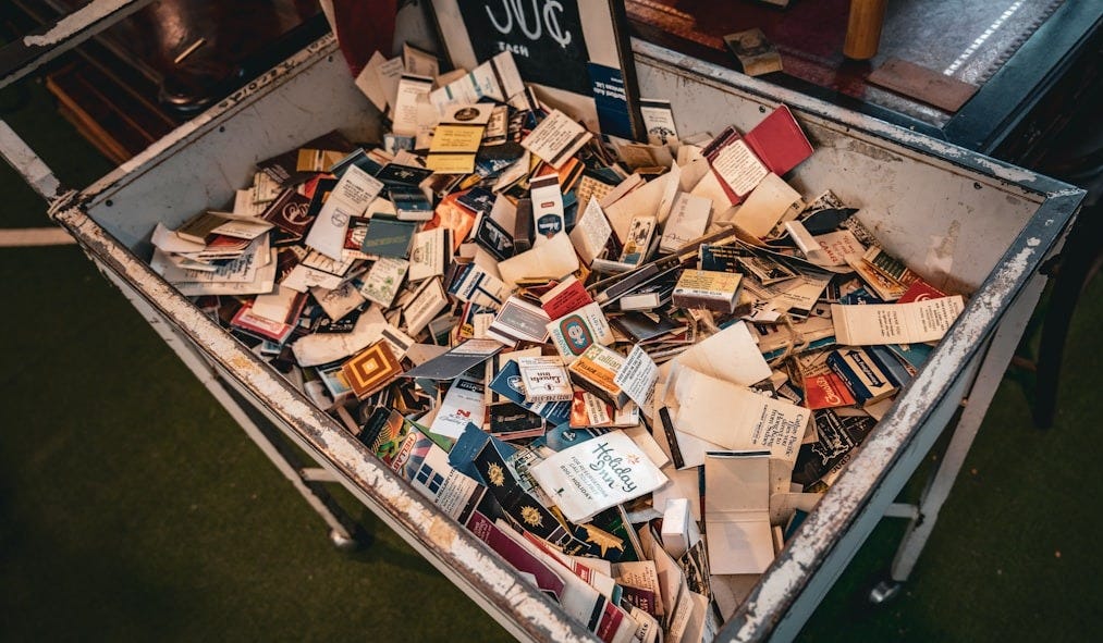 a box filled with lots of books on top of a table a box filled with lots of books on top of a table