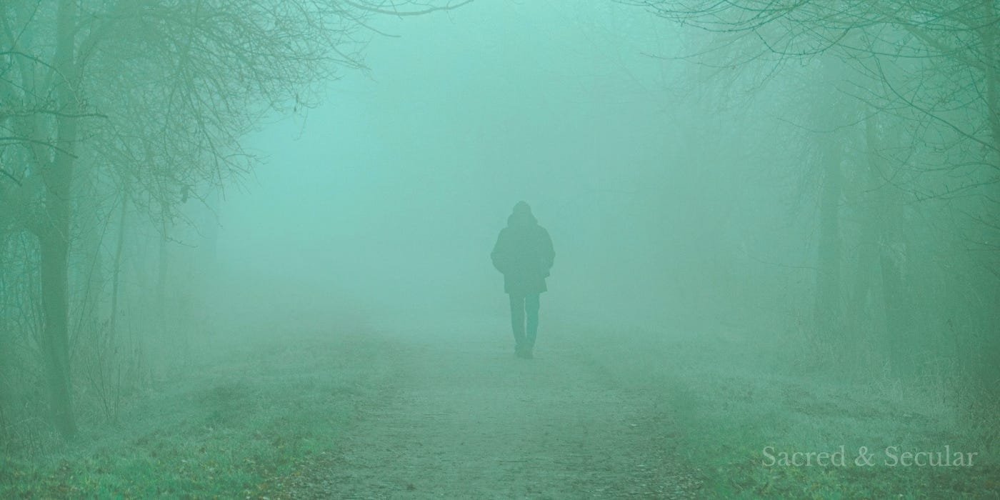 A solitary figure walks along a mist-covered path through a valley at dawn as soft golden light breaks through the clouds, illuminating the landscape ahead. A solitary figure walks along a mist-covered path through a valley at dawn as soft golden light breaks through the clouds, illuminating the landscape ahead.