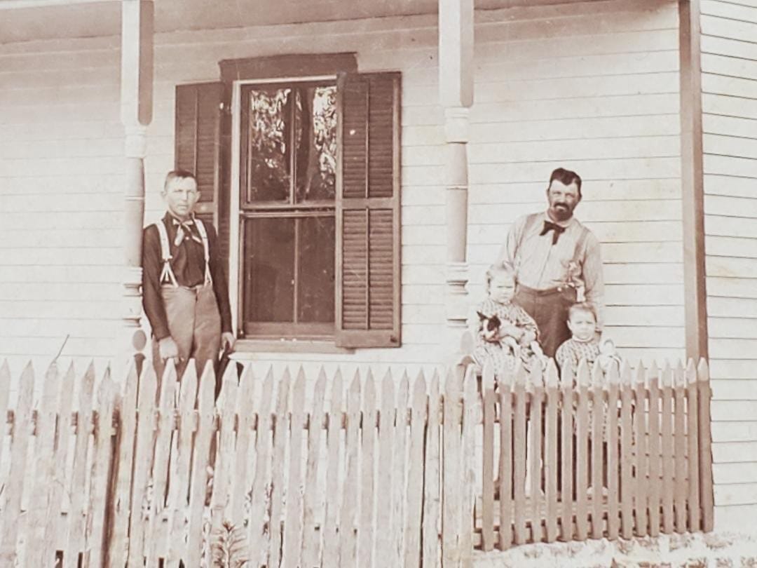 Herman (the man on the left) is on the porch at the Kauffman Farm. When he arrived in Missouri, he stayed with the Kauffman family and worked as a farmhand for them for several years until he had enough money to buy his farm. The picture was probably taken around 1890.