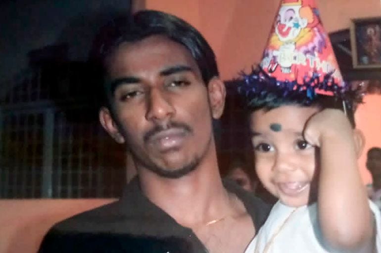 This undated photo provided by Sarmila Dharmalingam, shows her younger brother Nagaenthran K.Dharmalingam holding his nephew in Ipoh, Malaysia.