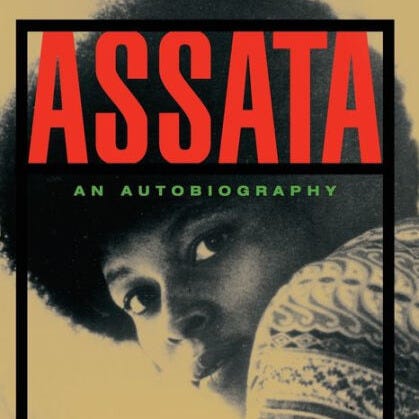 On the left is the cover of Assata: An Autobiography. The title overlays a photo of a young Assata Shakur with a large afro looking over her shoulder directly at the camera. On the right is the cover for Foxy: My Life in Three Acts featuring a full portrait, black and white photo of a middle-aged Pam Grier sitting with legs crossed. She is wearing a dark jacket with a large fur collar, a dark skirt and shiny dark boots.