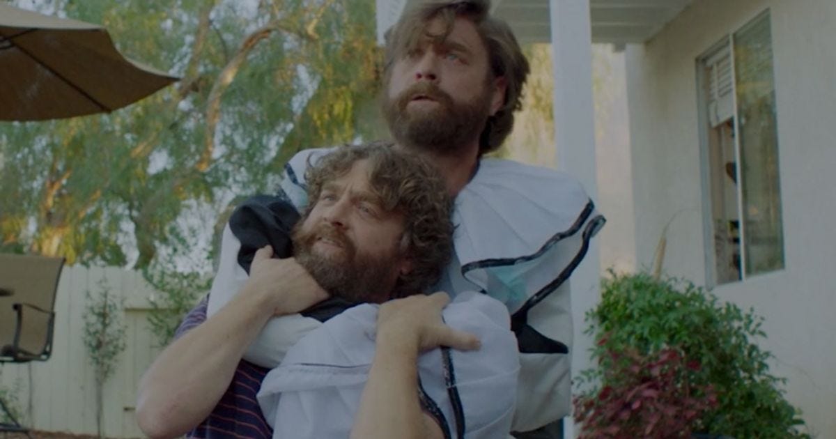 TV still from Baskets. Twin men wrestle in a backyard, one dressed like a clown