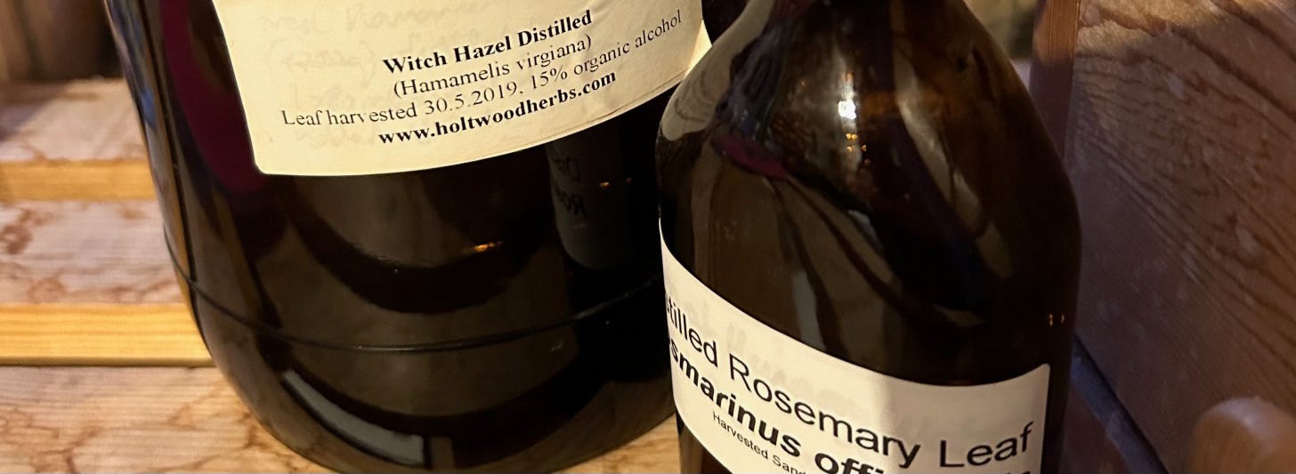 Labelled dark glass bottles containing distilled waters