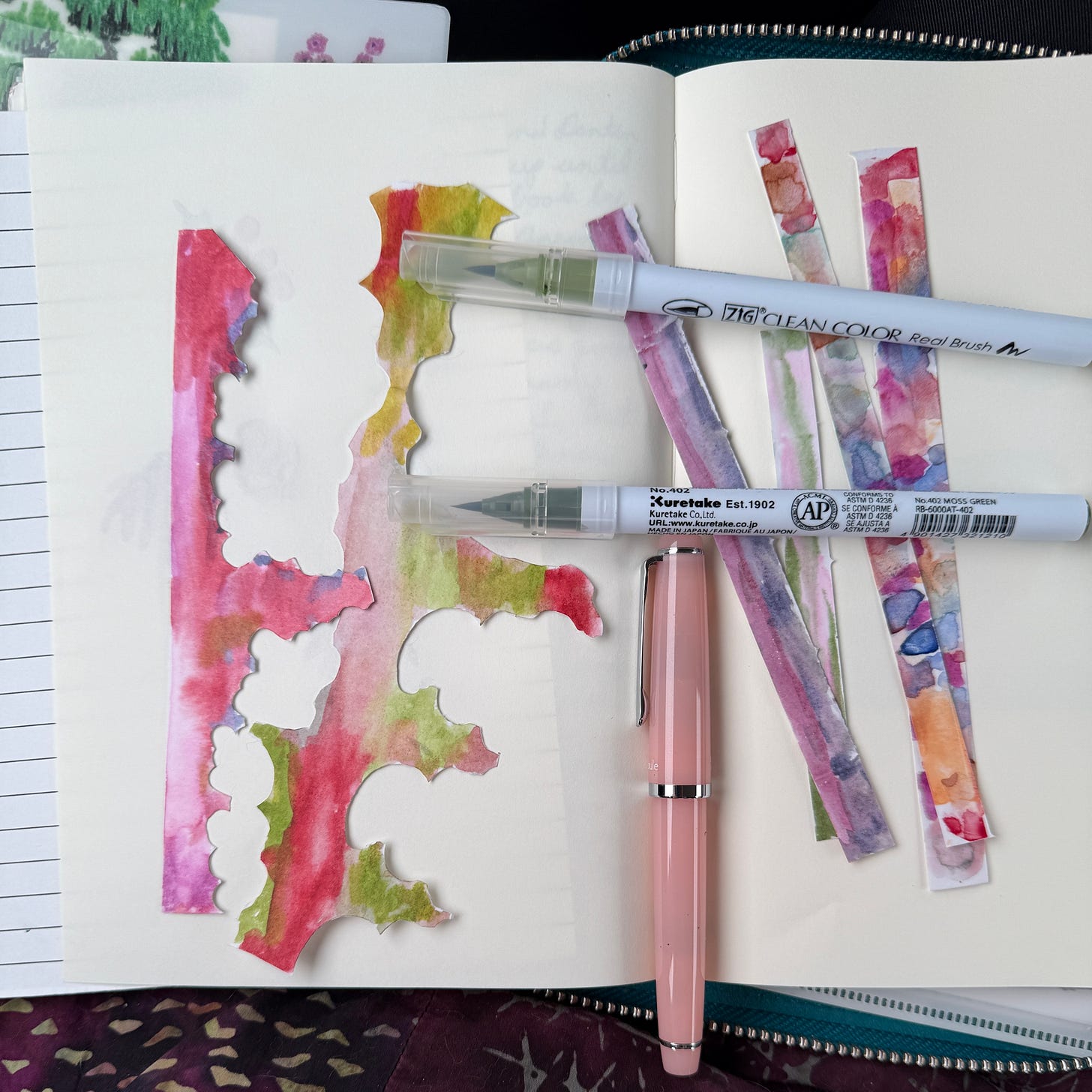 Brush pens over strips of washi paper painted in colors