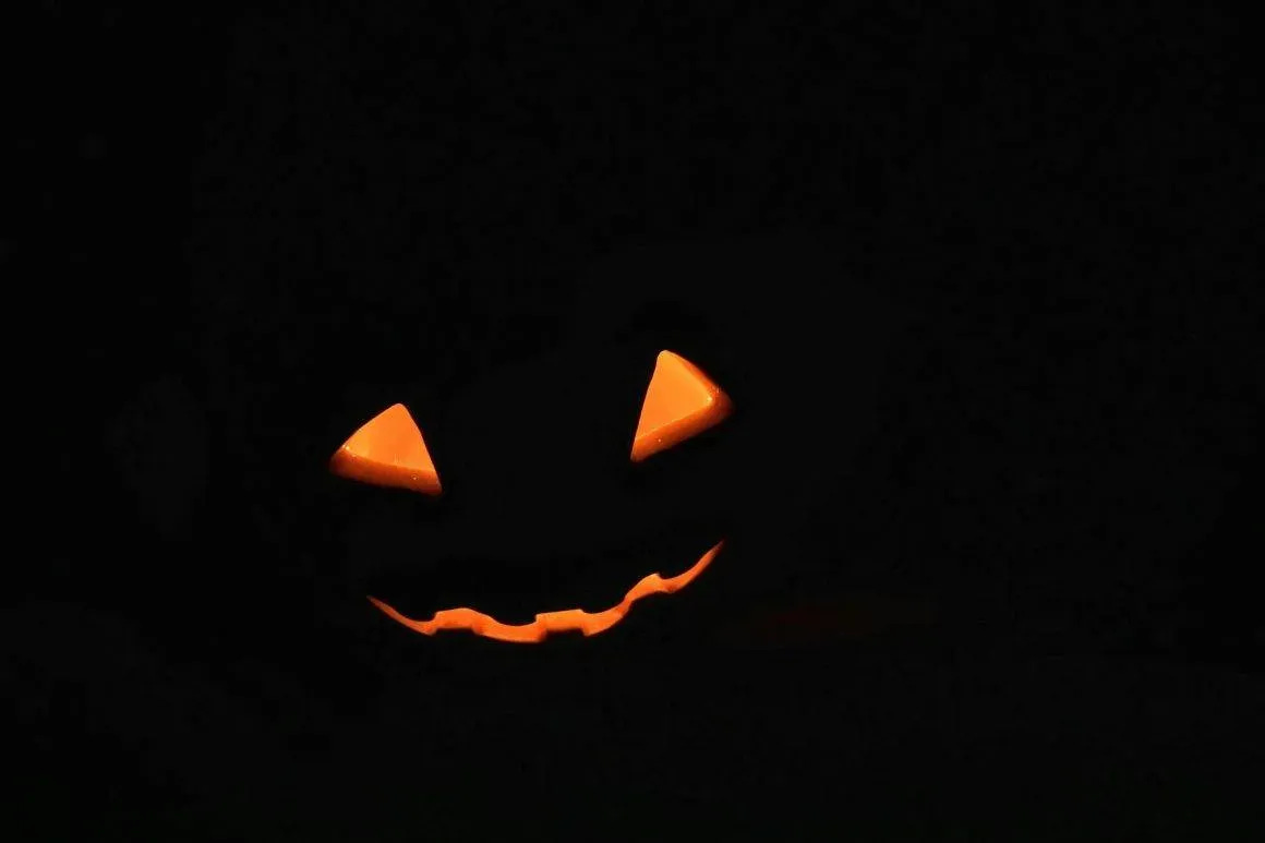 glowing jack o lantern face in darkness