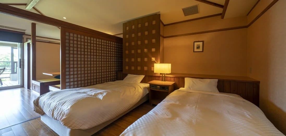 Two beds in accessible room 209 at Toba Seaside Hotel, with clear floor space between them