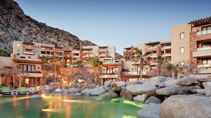 Exterior shot of Waldorf Astoria Los Cabos Pedregal with pool in foreground. Exterior shot of Waldorf Astoria Los Cabos Pedregal with pool in foreground.